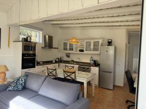 a living room with a couch and a table in a kitchen at Casa Brisa do Mar in Comporta