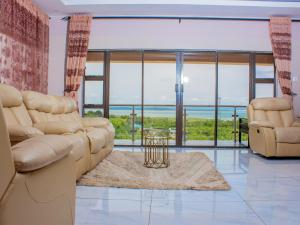 a living room with a view of the ocean at Samanyanga Resort in Kariba +4 photos
