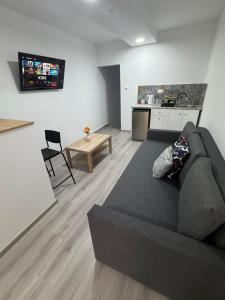 a living room with a couch and a kitchen at Limassol center Soul in Limassol