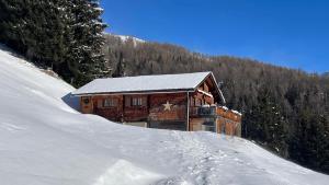 a log cabin in the snow on a mountain at Turner-Hütte in Heiligenblut