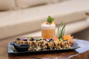 a plate of food on a table with a drink at Blue Peter Apartments in Protaras