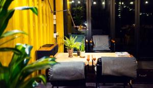 a table and chairs in a room with a yellow wall at Welcome Sunny House in Hongcheon
