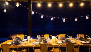 a long table with chairs and candles and lights at Welcome Sunny House in Hongcheon +3 photos