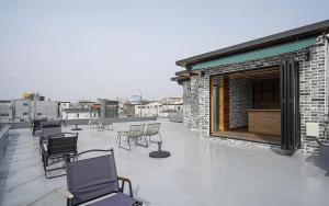 a patio with chairs and tables on a building at Gyeongju Wangrim 1984 in Gyeongju