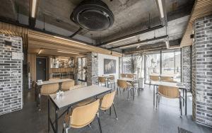 a dining room with tables and chairs in a building at Gyeongju Wangrim 1984 in Gyeongju +2 photos
