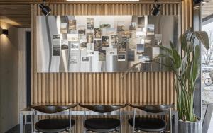 a restaurant with black chairs and a table with photos on the wall at Gyeongju Wangrim 1984 in Gyeongju