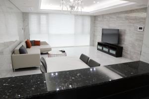 a large living room with a couch and a tv at W Residence Hotel Centum City in Busan