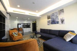 a living room with a couch and a table at Hilloria Residence Hotel in Serdivan