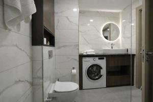 a bathroom with a washing machine and a sink at Hilloria Residence Hotel in Serdivan