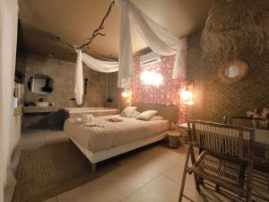 a bedroom with a bed and a tub in a room at L'expérience LOVE ROOM in Saint-Jean-Bonnefonds