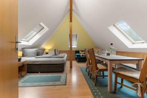 a living room with a bed and a table at Pension Schrammsteinbaude in Bad Schandau +99 photos