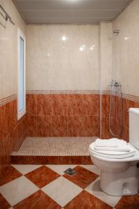 a bathroom with a shower and a toilet in it at Thalassa Hotel in Paleros +45 photos