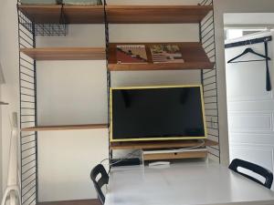 a tv sitting on a stand in a room at Cosy guesthouse close to cities in Hjärup