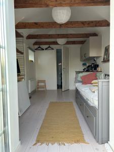 a bedroom with a bed and a dining room at Cosy guesthouse close to cities in Hjärup +3 photos