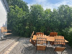 a wooden table and chairs sitting on a patio at Cosy guesthouse close to cities in Hjärup