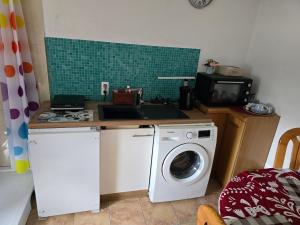a kitchen with a washing machine and a sink at Lieber Gruß 38 in Papenburg