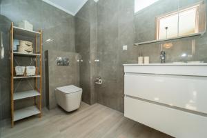 a bathroom with a toilet and a sink at Aegean Grace Villa in Iraklitsa +29 photos