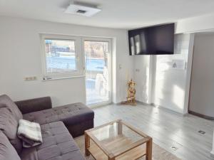a living room with a couch and a coffee table at Kreischberg Deluxe with Finnish Sauna in Sankt Lorenzen ob Murau