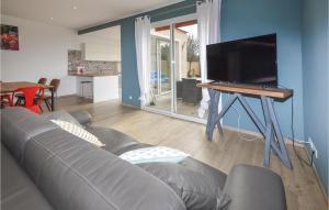 a living room with a couch and a flat screen tv at Villa Piscine Privative in Saint-Florent