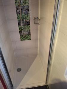 a shower with a glass door in a bathroom at Villa Beata in Nowe Warpno +23 photos