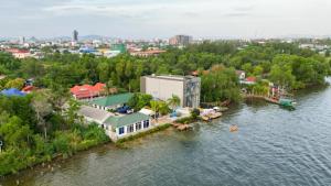 an aerial view of a house on an island in the water at The Cloud Homestay Kampot in Kampot