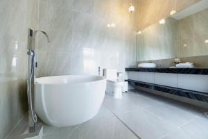 a bathroom with a large tub and a toilet at The Cloud Homestay Kampot in Kampot +72 photos