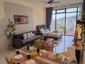 a living room with a couch and a bed at Georgetown#Beacon Executive Suite SkyPool#Luxury&Glamorous Suite#2BR#Living Room with Queen Bed in George Town
