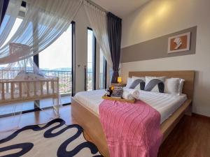 a bedroom with a bed and a large window at Georgetown#Beacon Executive Suite SkyPool#Luxury&Glamorous Suite#2BR#Living Room with Queen Bed in George Town +247 photos