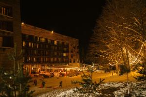 a group of people standing outside of a building at night at Kokhta Bakuriani in Bakuriani