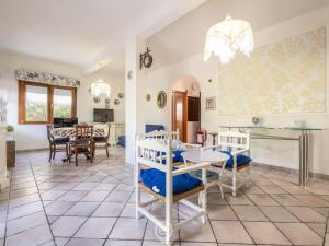 a kitchen and living room with a table and chairs at Estay - Villa Foxi Serenity - Exclusive holiday in Quartu SantʼElena +24 photos