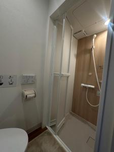 a shower stall in a bathroom with a toilet at JAM Hostel Kyoto Gion in Kyoto