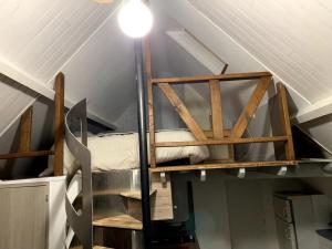 a room with a bunk bed in a attic at Gîte les Crayons in Gaillon
