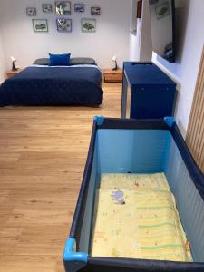 a bedroom with a bed and a crib in it at Außergewöhnliches Apartment in bester Lage in Biberach an der Riß