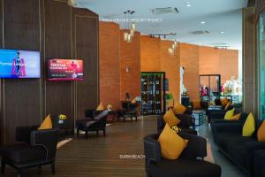a waiting room with couches and chairs and a tv at Suite With Sea View By Mida Grande Resort in Surin Beach