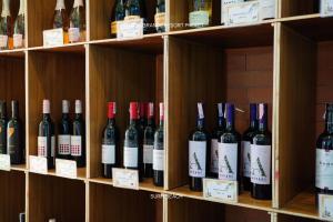 a bunch of bottles of wine sitting on shelves at Suite With Sea View By Mida Grande Resort in Surin Beach