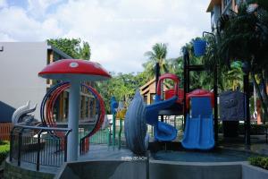 a playground in a park with a slide at Suite With Sea View By Mida Grande Resort in Surin Beach +22 photos