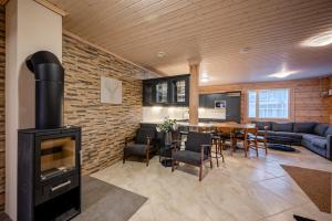 a living room with a fireplace and a dining room at Villa Lily ski slopes 300 m, Jacuzzi for extra fee in Himos +28 photos