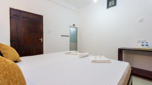a bedroom with a bed with two towels on it at Pearl Guest House in Dambulla +81 photos