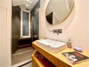 a bathroom with a sink and a mirror at Amazing San Lorenzo 19 Apt with Private Parking in Genoa +19 photos
