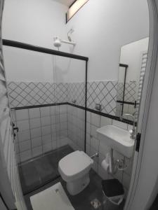 a bathroom with a toilet and a sink at Hotel XV in Piracicaba +23 photos