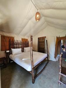 a bedroom with a large bed in a tent at Deshadan Jungle in Kanthalloor