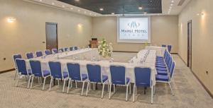 a meeting room with a long table and blue chairs at Margi Hotel in Edirne +26 photos