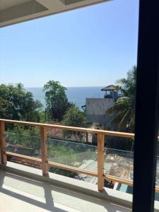 a balcony with a view of the ocean at W15 Hiriketiya in Dickwella