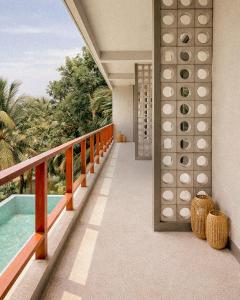 a balcony of a resort with a swimming pool at W15 Hiriketiya in Dickwella