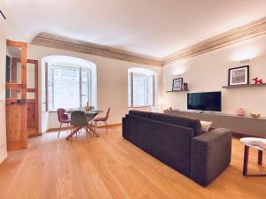 a living room with a couch and a table at Amazing San Lorenzo 19 Apt with Private Parking in Genoa
