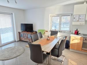 a dining room with a table and chairs in a kitchen at Kreischberg Superior with Sauna in Sankt Lorenzen ob Murau