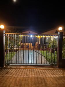 a gate in front of a house at night at Bula Homestay in Labasa