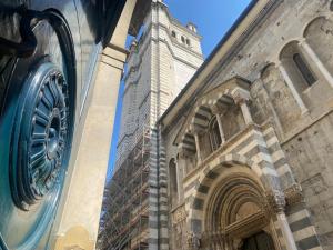 a building with a clock tower in front of it at Amazing San Lorenzo 19 Apt with Private Parking in Genoa