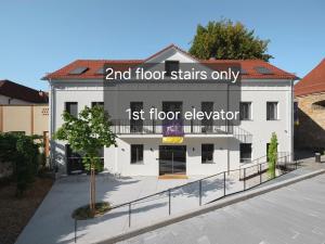 a white building with the words floor stairs onlyost floor elevation at Hiša Barbara in Celje