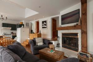 a living room with a couch and a fireplace at Waterfront & Nature - Chalet Lac Clair in Entrelacs